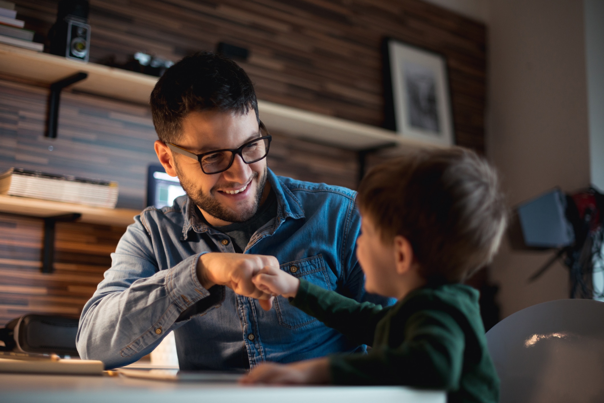 Behavior Therapist and child fist bumping during a therapy session at home.